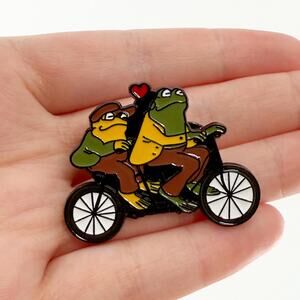 Frog and Toad Together on Bike Enamel Pin